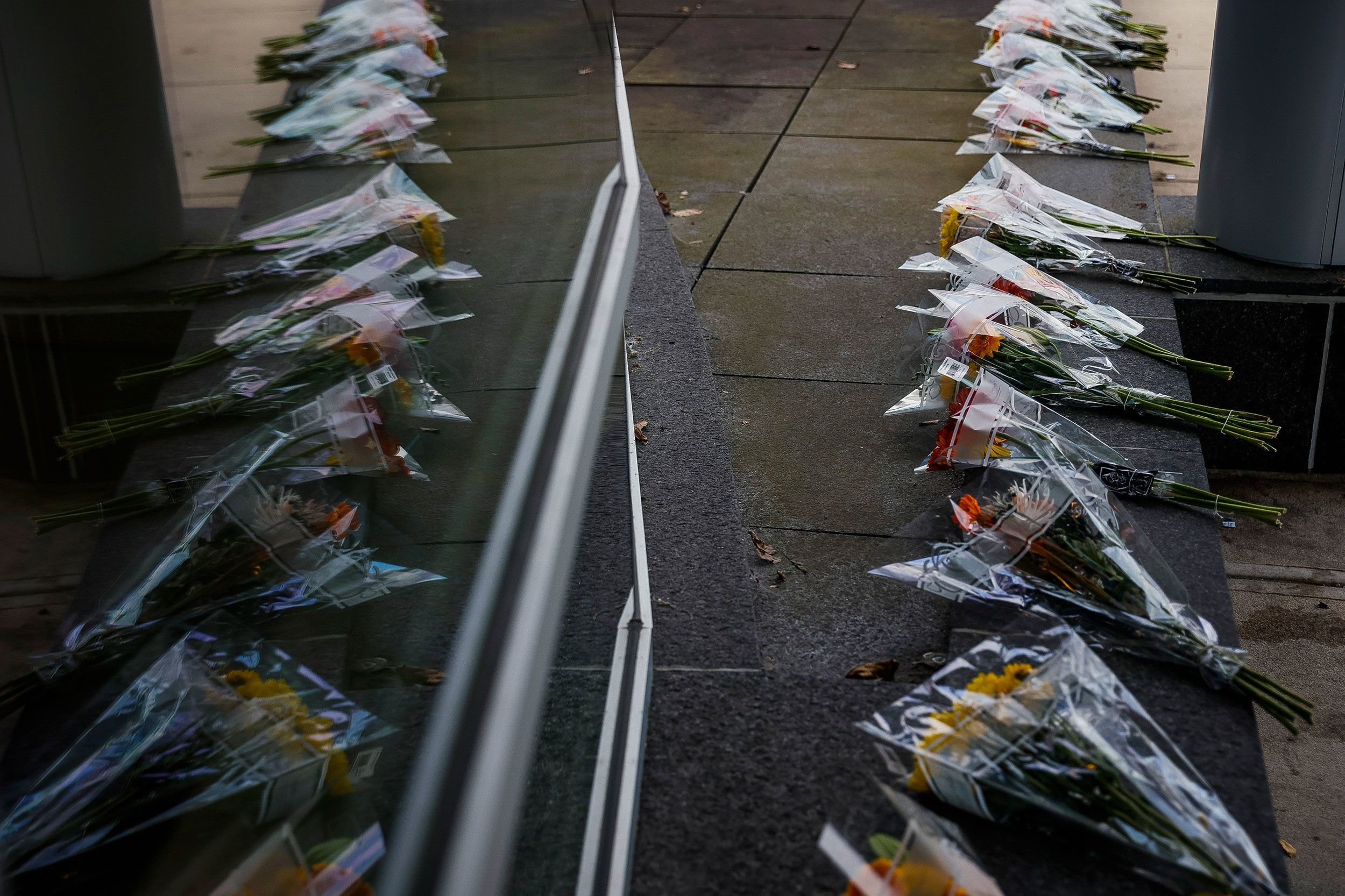 Bouquets of flowers and notes of encouragement are placed outside of the emergency department at Central Maine Medical Center on Friday in Lewiston.