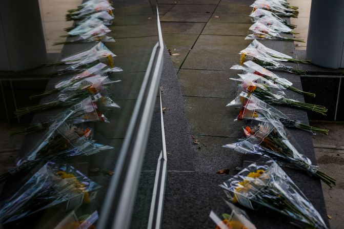 Bouquets of flowers and notes of encouragement are placed outside of the emergency department at Central Maine Medical Center on Friday in Lewiston. The hospital closed their ER and is currently only treating victims from Wednesday night's shooting in Lewiston. 