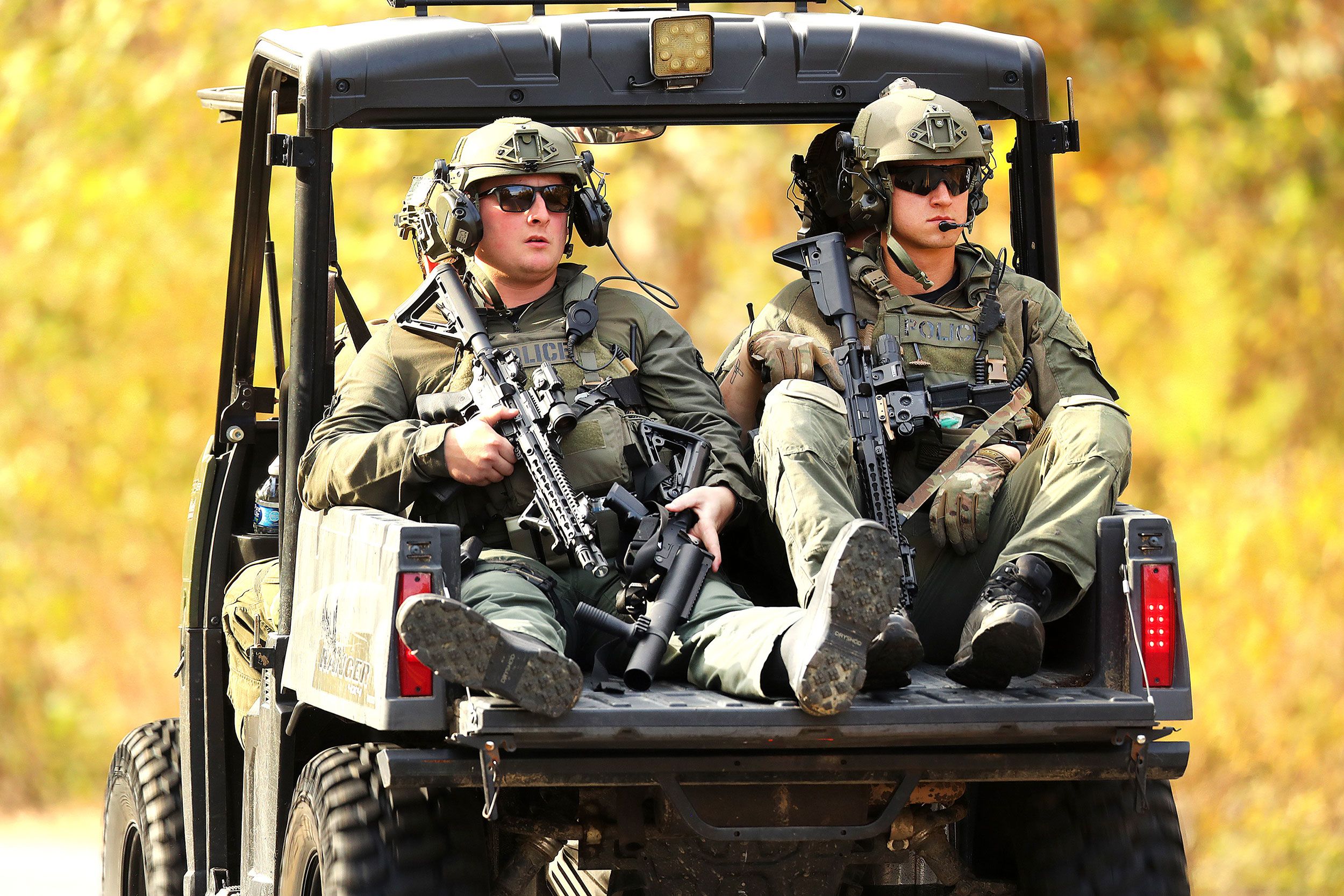 Southern Maine Regional SWAT team members patrol on Friday near the Lisbon boat launch, where suspect Robert Card abandoned his car.