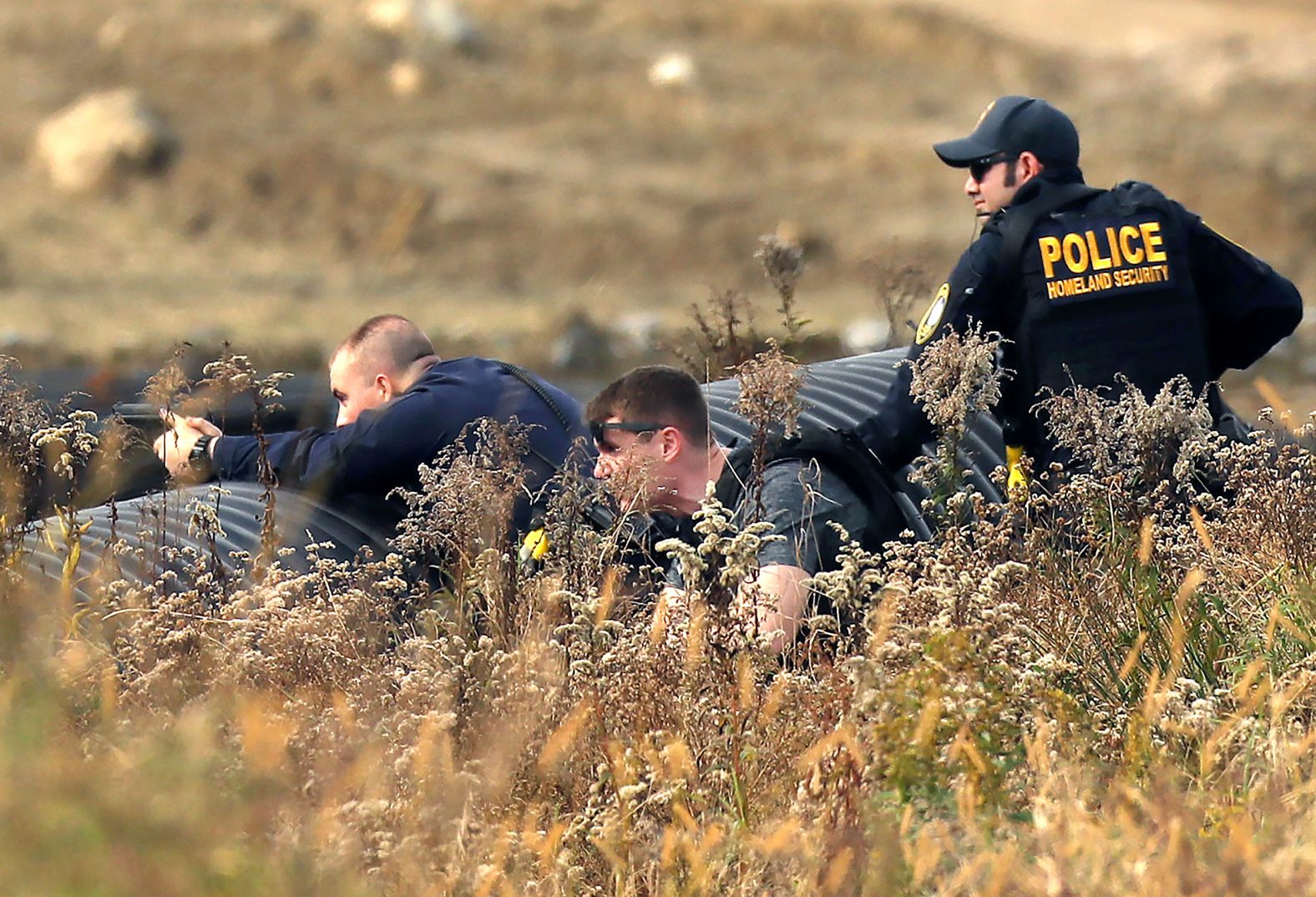 Police take aim after people in the area heard a gunshot at a farm in Lisbon on Friday.