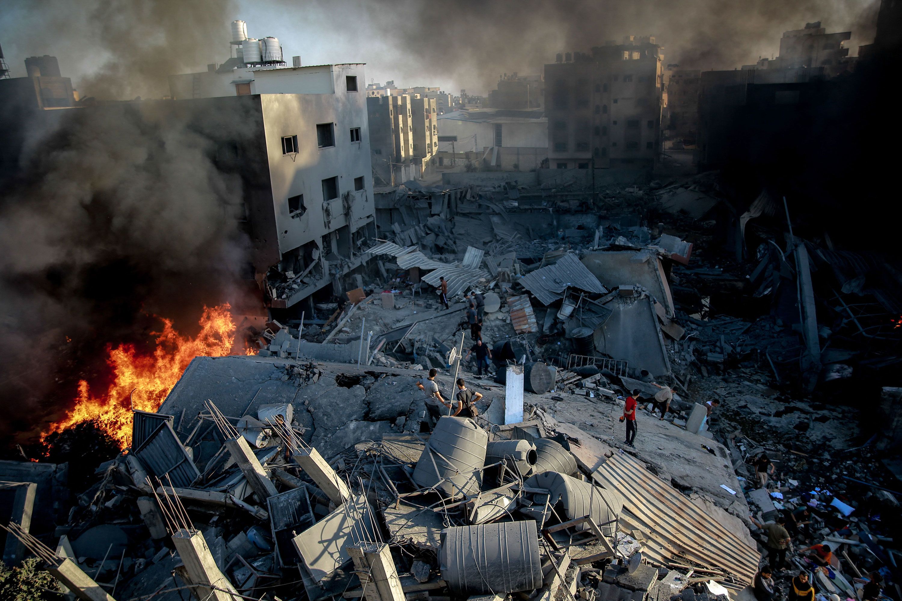 Smoke and fire rise from a leveled building after an Israeli strike on Gaza on October 26.