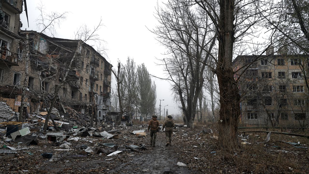 AVDIIVKA, UKRAINE - OCTOBER 26: Two Ukrainian soldiers walk along the destroyed city in the fog on October 26, 2023 in Avdiivka, Ukraine. Fighting has intensified in recent days after Russia launched a major offensive here earlier this month. (Vlada Liberova / Libkos via Getty Images)