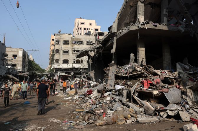 People check the destruction following Israeli strikes on Al-Shatee camp in Gaza City on October 28.