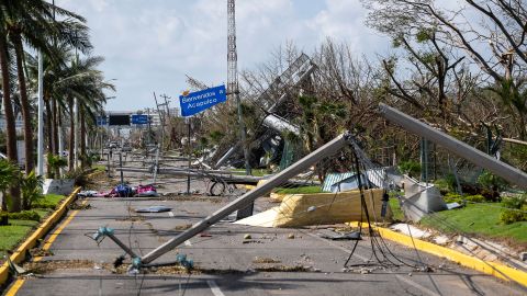 Downed electrical poles and lines blown over by Hurricane Otis blanket a road in Acapulco, Mexico, Friday, Oct. 27, 2023. (AP Photo/Felix Marquez)
