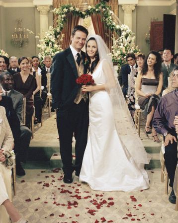 Perry and Cox pose for a photo during the 2001 "Friends" episode "The One With Monica And Chandler's Wedding."
