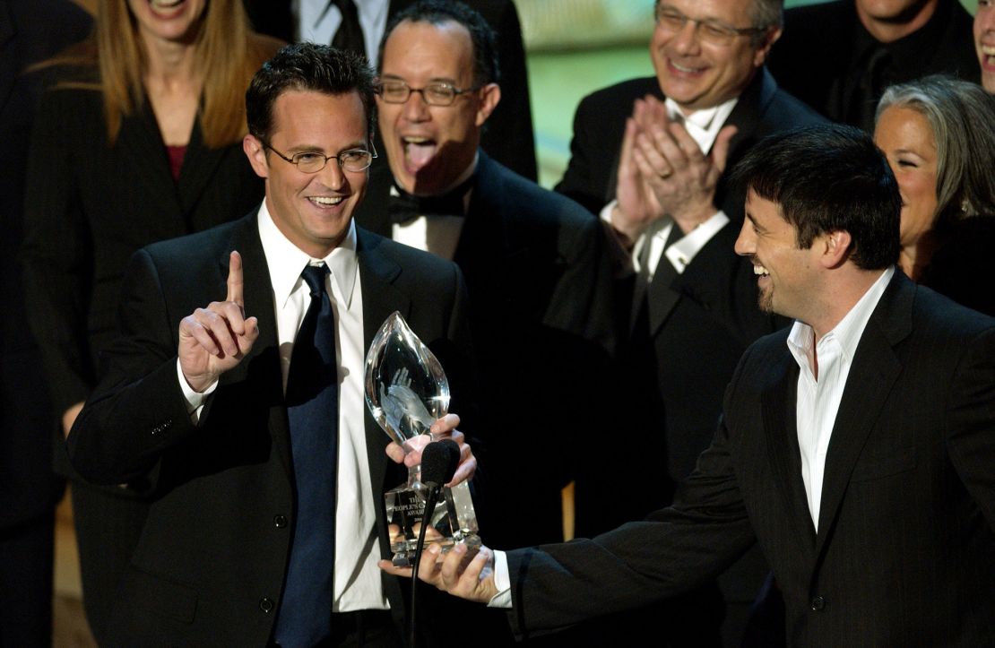 Actor Matthew Perry, left prepares to make a statement as fellow cast member Matt LeBlanc hands over the award they won for favorite television comedy series at the 30th Annual People's Choice Awards Sunday, Jan. 11, 2004, in Pasadena, Calif. (AP Photo/Mark J. Terrill)