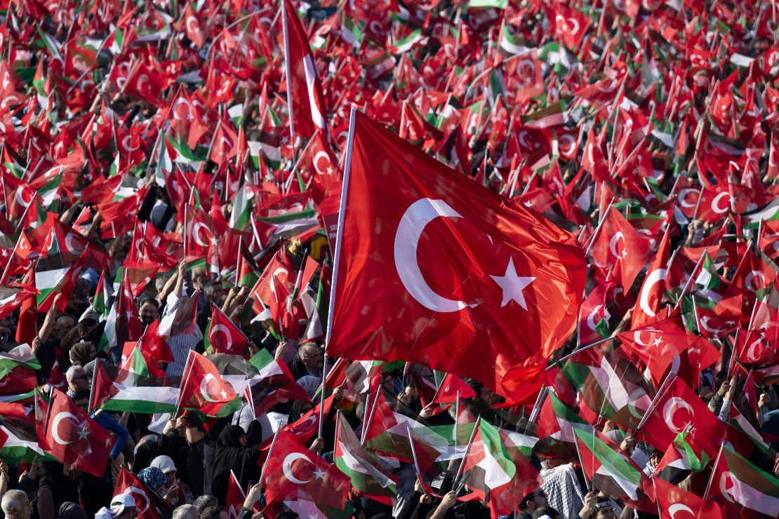 TOPSHOT - People wave Turkish and Palestinian flags as Turkish President speaks during a rally organised by the AKP party in solidarity with the Palestinians in Gaza, in Istanbul on October 28, 2023. Erdogan's Islamic-rooted party staged a massive pro-Palestinian rally in Istanbul on October 28, 2023 that the Turkish leader said had drawn a crowd of 1.5 million. He unleashed a scathing attack at Israel and its Western supporters after taking the stage with a microphone in his hand. "The main culprit behind the massacre unfolding in Gaza is the West," Erdogan told the Turkish and Palestinian flag-waving crowd. (Photo by YASIN AKGUL / AFP) (Photo by YASIN AKGUL/AFP via Getty Images)