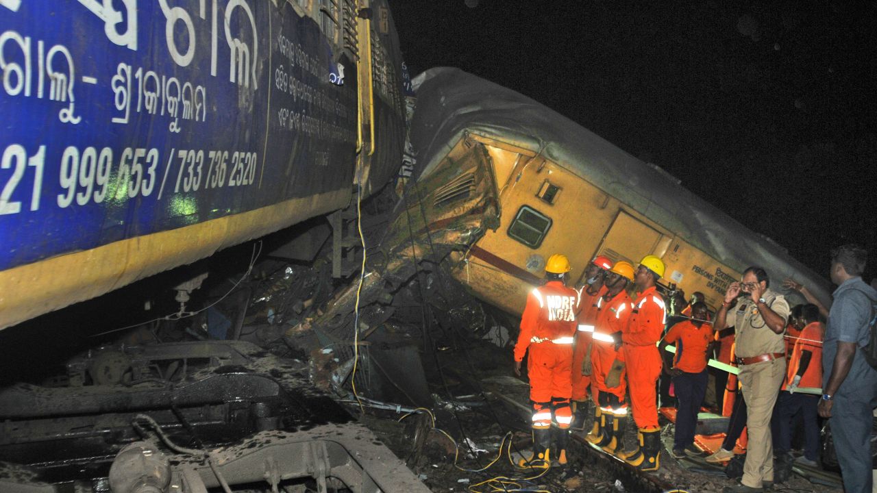 Rescuers and others stand after two passenger trains collided in Vizianagaram district, Andhra Pradesh state, India, Sunday, Oct.29, 2023. The crash happened when an incoming train slammed into a stationary train, leading to derailment of at least three rail cars. (AP Photo)