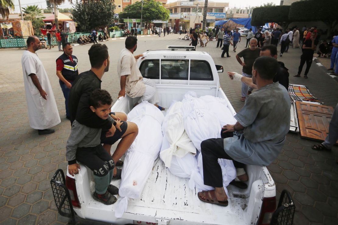 DEIR AL BALAH, GAZA - OCTOBER 28: People take the bodies of their loved ones out of the mortuary of Al Aqsa Martyrs Hospital to bury them as Israeli attacks continue on the 22nd day in Deir al Balah, Gaza on October 28, 2023. (Photo by Ashraf Amra/Anadolu via Getty Images)