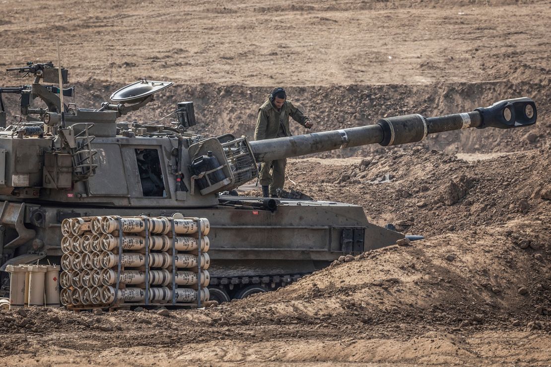 An Israeli soldier stands on artillery near the border with Gaza during Israeli bombardment in Sderot, Israel on October 28, 2023.