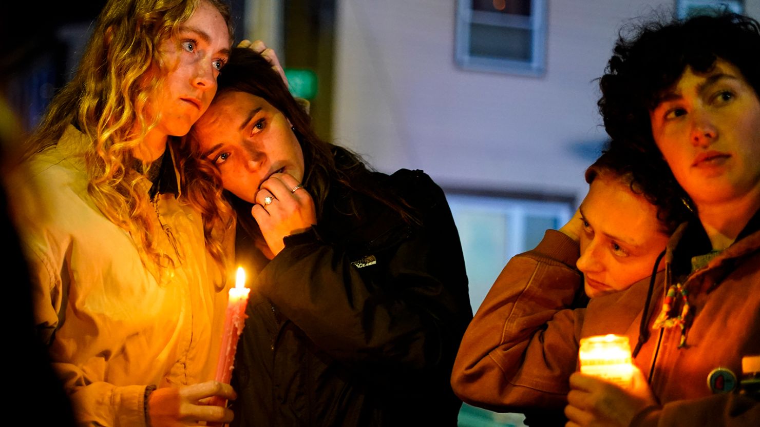 People linger after a vigil for the victims of Wednesday's mass shootings, Sunday, October 29, 2023, outside the Basilica of Saints Peter and Paul in Lewiston, Maine.