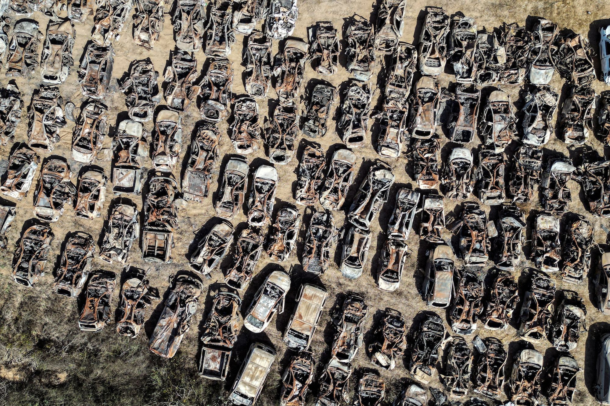 Vehicles destroyed by Hamas during the October 7 attack on Israel are seen collected in a field near the Israel's border with Gaza on October 30.