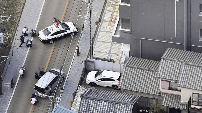 This aerial photo shows first responders take position outside the post office where a man is believed to hole up in Warabi city, Saitama prefecture, north of Tokyo, Tuesday, Oct. 31, 2023. (Kyodo News via AP)