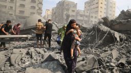 TOPSHOT - Palestinians evacuate the area following an Israeli airstrike on the Sousi mosque in Gaza City on October 9, 2023. Israel continued to battle Hamas fighters on October 9 and massed tens of thousands of troops and heavy armour around the Gaza Strip after vowing a massive blow over the Palestinian militants' surprise attack. (Photo by Mahmud HAMS / AFP) (Photo by MAHMUD HAMS/AFP via Getty Images)