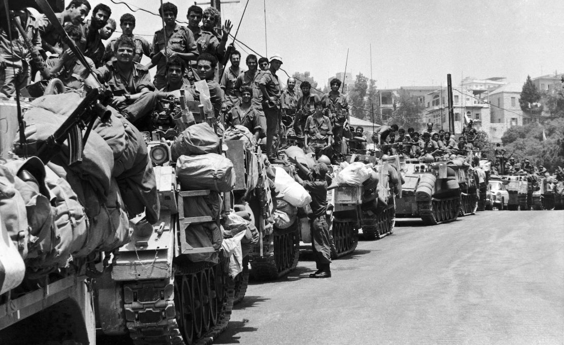 A long line of Israeli armoured personnel carriers and their crews wait on a street on the outskirts of Beirut, on July 27, 1982, for the order to proceed into the capital. (AP Photo/Nash)