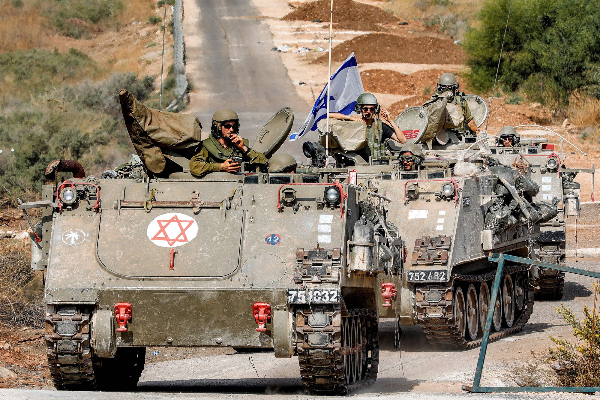 Israeli army vehicles move along a road near the northern town of Kiryat Shmona close to the border with Lebanon on October 31.