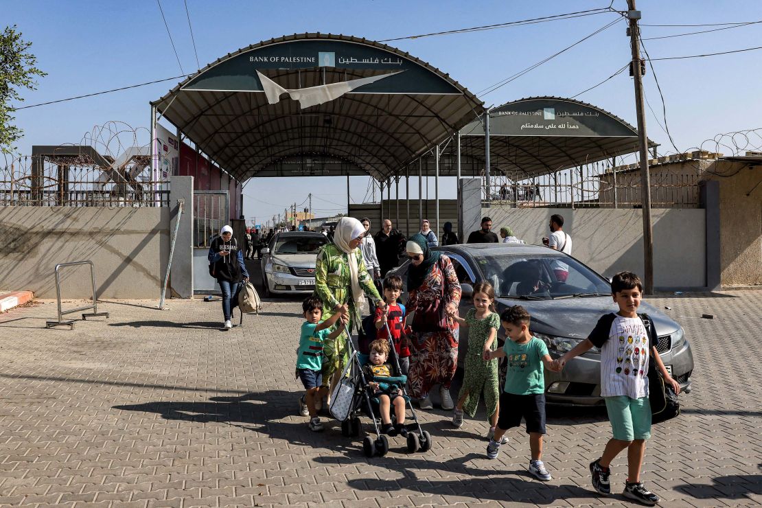 People enter the Rafah border crossing in the southern Gaza Strip before crossing into Egypt on November 1, 2023. Scores of foreign passport holders trapped in Gaza started leaving the war-torn Palestinian territory on November 1 when the Rafah crossing to Egypt was opened up for the first time since the October 7 Hamas attacks on Israel, according to AFP correspondents. (Photo by Mohammed ABED / AFP) (Photo by MOHAMMED ABED/AFP via Getty Images)