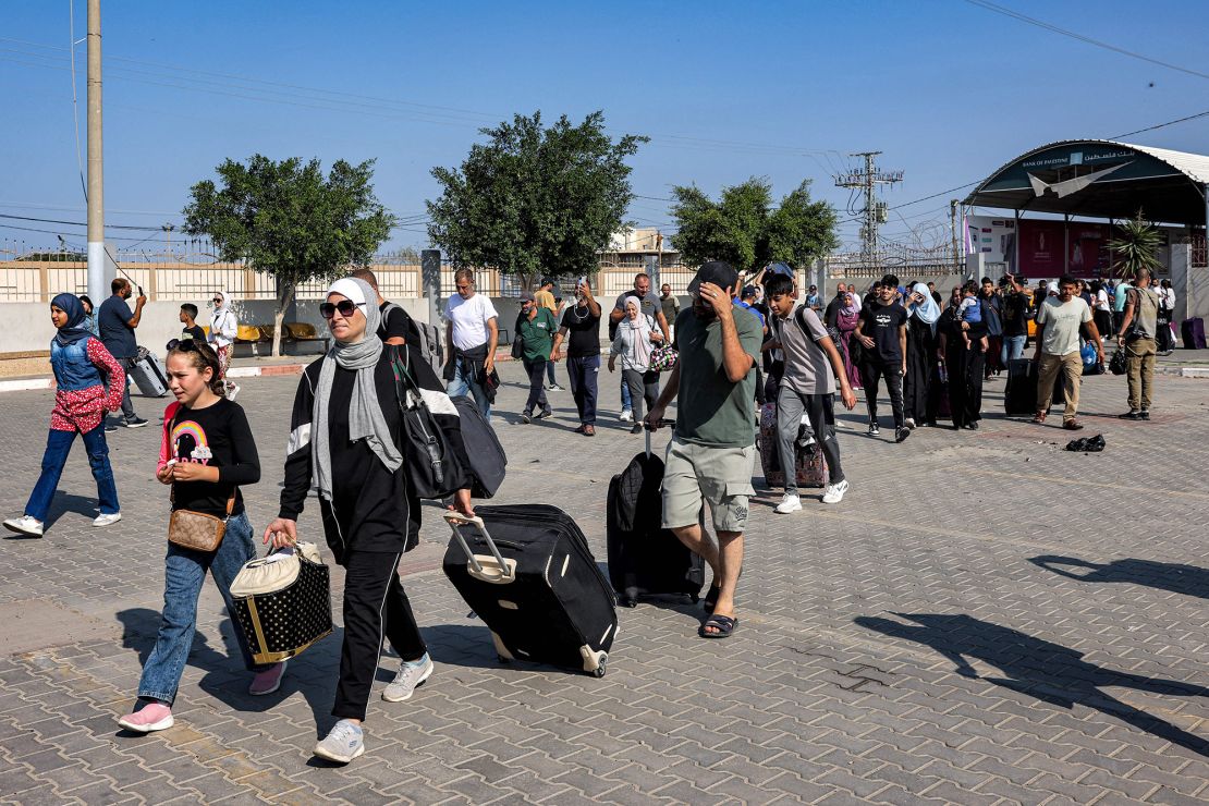 People enter the Rafah border crossing in the southern Gaza Strip before crossing into Egypt on November 1, 2023. Scores of foreign passport holders trapped in Gaza started leaving the war-torn Palestinian territory on November 1 when the Rafah crossing to Egypt was opened up for the first time since the October 7 Hamas attacks on Israel, according to AFP correspondents. (Photo by Mohammed ABED / AFP) (Photo by MOHAMMED ABED/AFP via Getty Images)