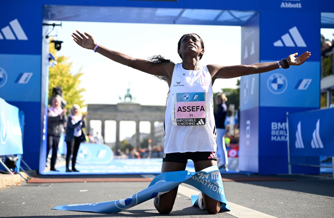 Ethiopia's Tigist Assefa celebrates after smashing the women's marathon world record by crossing the finish line to win the women's race of the Berlin Marathon on September 24, 2023 in Berlin, Germany. (Photo by Tobias SCHWARZ / AFP) (Photo by TOBIAS SCHWARZ/AFP via Getty Images)