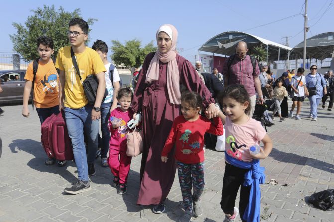 Palestinians move through the Rafah border crossing between Gaza and Egypt, on November 1. Injured Palestinians and foreign nationals from Gaza have <a href="https://edition.cnn.com/2023/11/01/middleeast/rafah-border-crossing-egypt-foreign-nationals-gaza-intl-hnk/index.html" target="_blank">started crossing the border</a> into Egypt, officials and Egyptian media said, in the first sanctioned exodus from the besieged enclave in weeks.