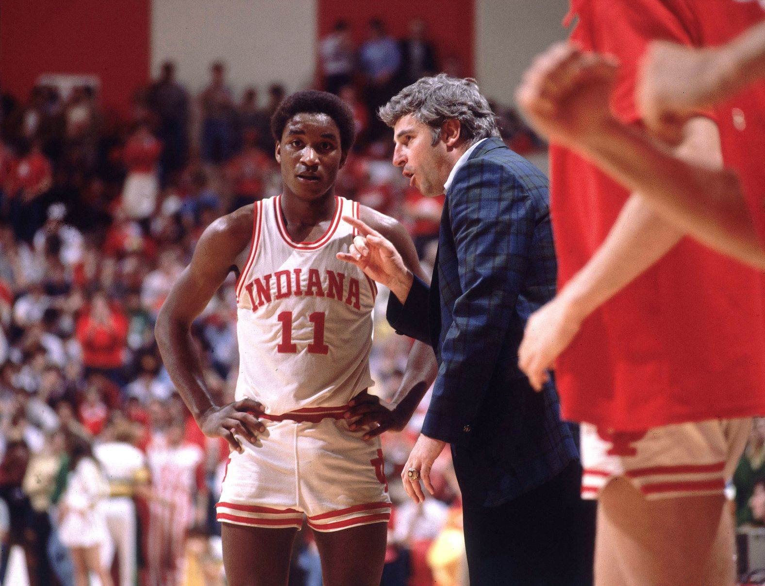 Knight talks to Indiana's Isiah Thomas on the sidelines during a game in 1981.