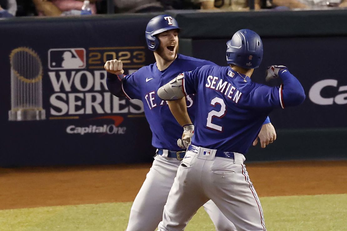 PHOENIX, AZ - NOVEMBER 01: Jonah Heim #28 and Marcus Semien #2 of the Texas Rangers celebrate after Semien's two-run home run in the ninth inning during Game 5 of the 2023 World Series between the Texas Rangers and the Arizona Diamondbacks at Chase Field on Wednesday, November 1, 2023 in Phoenix, Arizona. (Photo by Chris Coduto/MLB Photos via Getty Images)