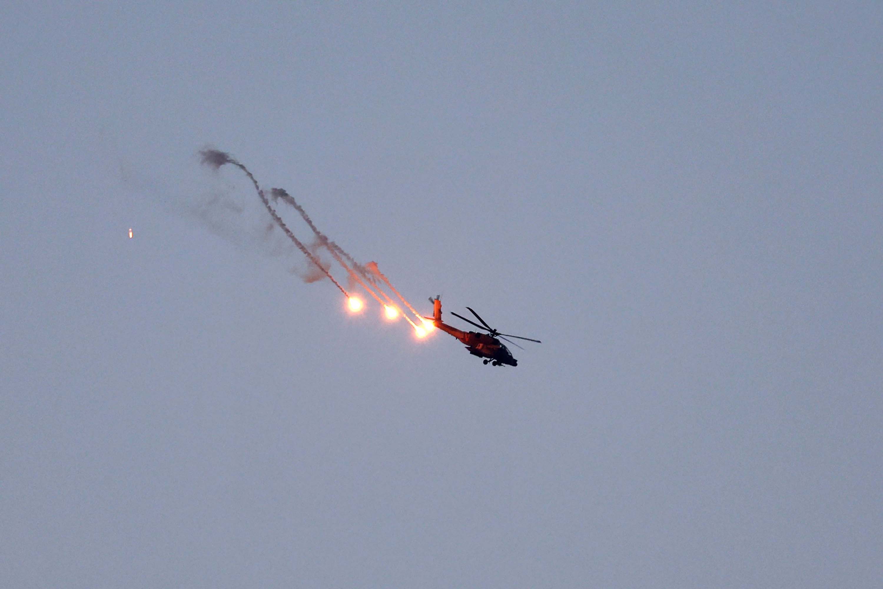 An Israeli Apache helicopter fires flares over Gaza, seen from Sderot, Israel, on November 1.