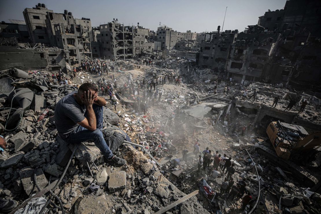 A man sits on debris as Palestinians conduct a search and rescue operation after the second bombardment to the Jabalya refugee camp in Gaza City, on November 1. Credit: Ali Jadallah/Anadolu/Getty Images