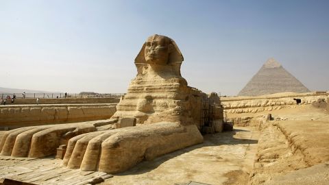 The Great Sphinx of Giza, a large half-human, half-lion Sphinx statue on the Giza Plateau on the west bank of the Nile River, near modern-day Cairo seen with the Chephren (Khafre) Pyramid in the background, 23 October 2007. The Great Sphinx is one of the largest single-stone statues on Earth, and is commonly believed to have been built by ancient Egyptians in the 3rd millennium BC, somewhere between 2520 BC and 2494 BC. The debate surrounding the real-life model used for the face when it was built, and by whom, have earned the title "Riddle of the Sphinx," a nod to its Greek namesake, although this phrase should not be confused with the original Greek legend. AFP PHOTO/CRIS BOURONCLE        (Photo credit should read CRIS BOURONCLE/AFP via Getty Images)