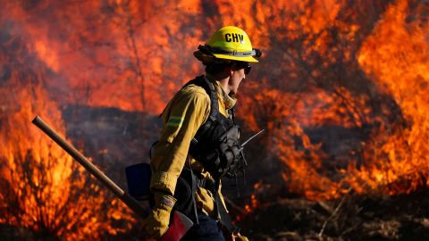 A firefighter works to extinguish the Highland Fire, a wind driven wildfire near Aguanga, California, U.S., October 31, 2023.  REUTERS/Mike Blake     TPX IMAGES OF THE DAY