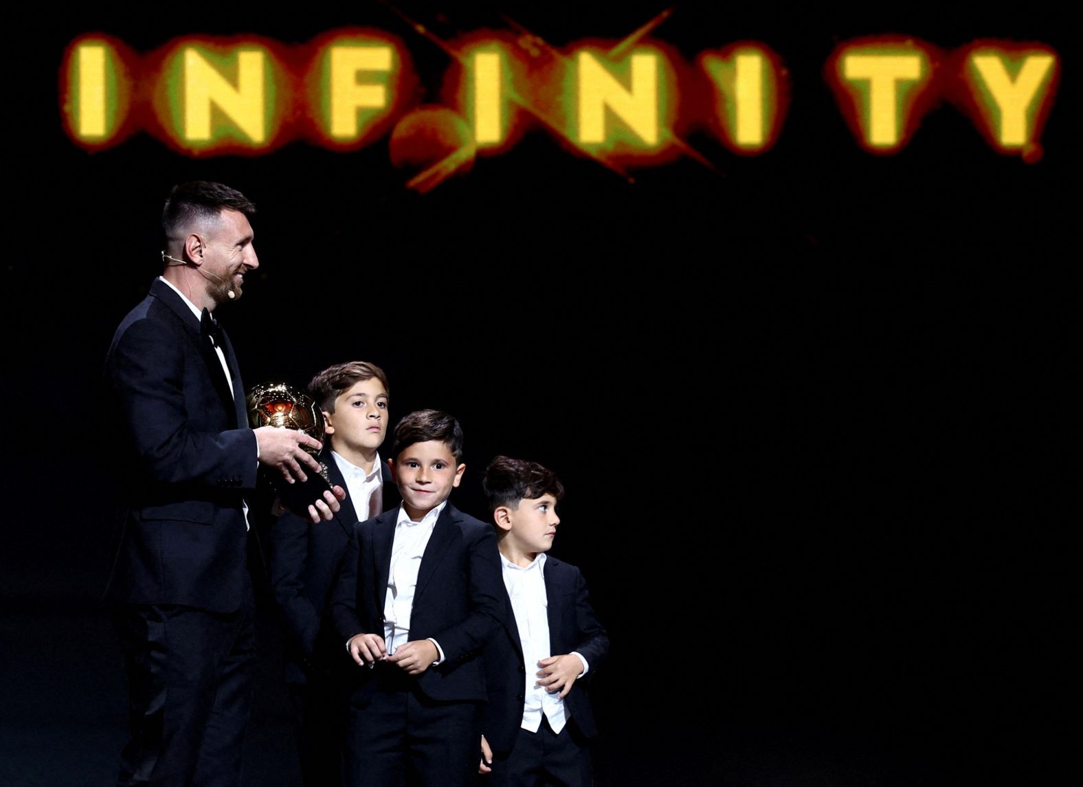 Lionel Messi stands on stage with his sons Thiago, Mateo and Ciro after <a href="https://www.cnn.com/2023/10/30/sport/lionel-messi-aitana-bonmati-ballon-dor-spt-intl/index.html" target="_blank">winning his eighth men's Ballon d'Or</a> in Paris on Monday, October 30.