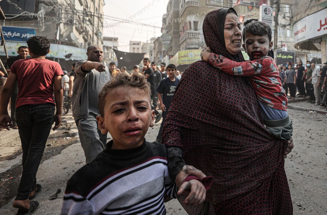 GAZA STRIP, GAZA - NOVEMBER 02: (EDITORS NOTE: Image depicts graphic content) A woman and children, all injured, try to get to the safety amid destruction and chaos caused by Israeli airstrikes on Bureij refugee camp in central Gaza Strip on November 02, 2023. (Photo by Mustafa Hassona/Anadolu via Getty Images)