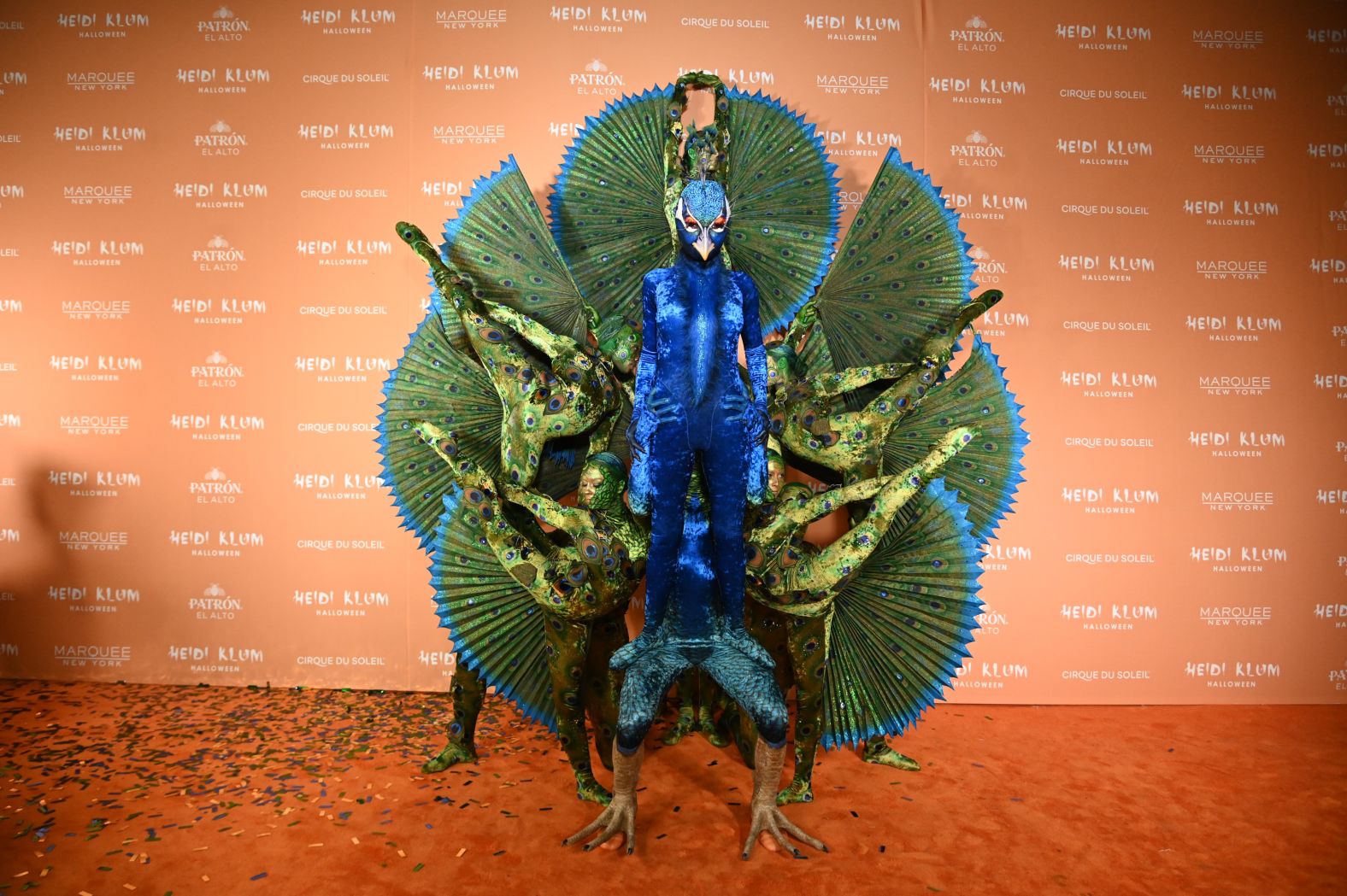 Heidi Klum, <a href="https://www.cnn.com/style/best-celebrity-halloween-costumes-2023/index.html" target="_blank">dressed as a peacock</a> with a team of acrobats serving as her plume of feathers, attends her annual Halloween party in New York on Tuesday, October 31.