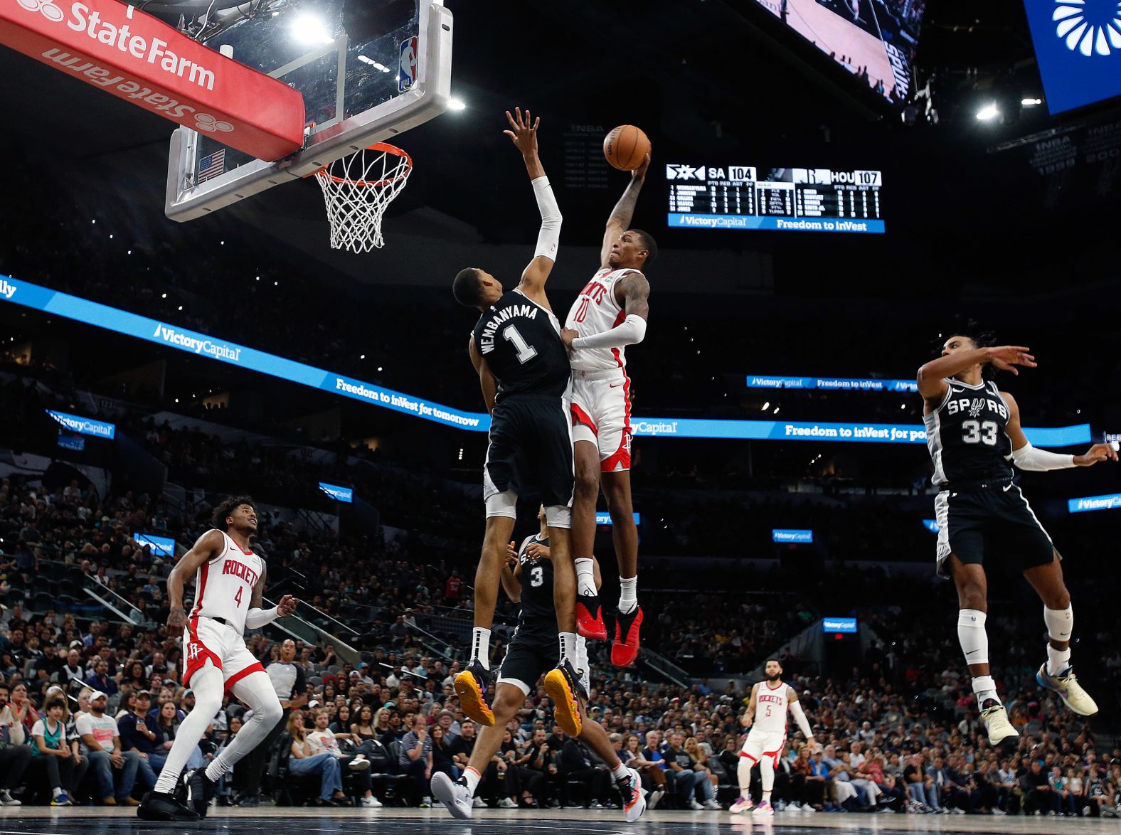 Jabari Smith Jr. of the Houston Rockets tries to dunk over San Antonio Spurs rookie Victor Wembanyama on Friday, October 27. <a href="https://www.cnn.com/2023/10/28/sport/victor-wembanyama-spurs-win-spt-intl/index.html" target="_blank">The Spurs beat the Rockets 126-122 in overtime</a>.