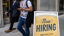 People walk past a restaurant, with a hiring sign outside, in Washington, DC on October 5, 2023. Private payrolls rose 89,000 last month after climbing 180,000 in August, according to figures published Wednesday by the ADP Research Institute, the fewest number of jobs since the start of 2021 in September. (Photo by ANDREW CABALLERO-REYNOLDS / AFP) (Photo by ANDREW CABALLERO-REYNOLDS/AFP via Getty Images)
