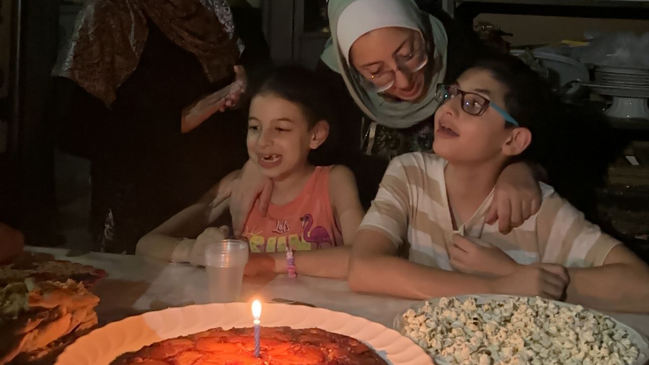 Hashem celebrates with his favorite cake -- pineapple -- alongside sister Basma, mother Hiba and grandmother Teta Reema.