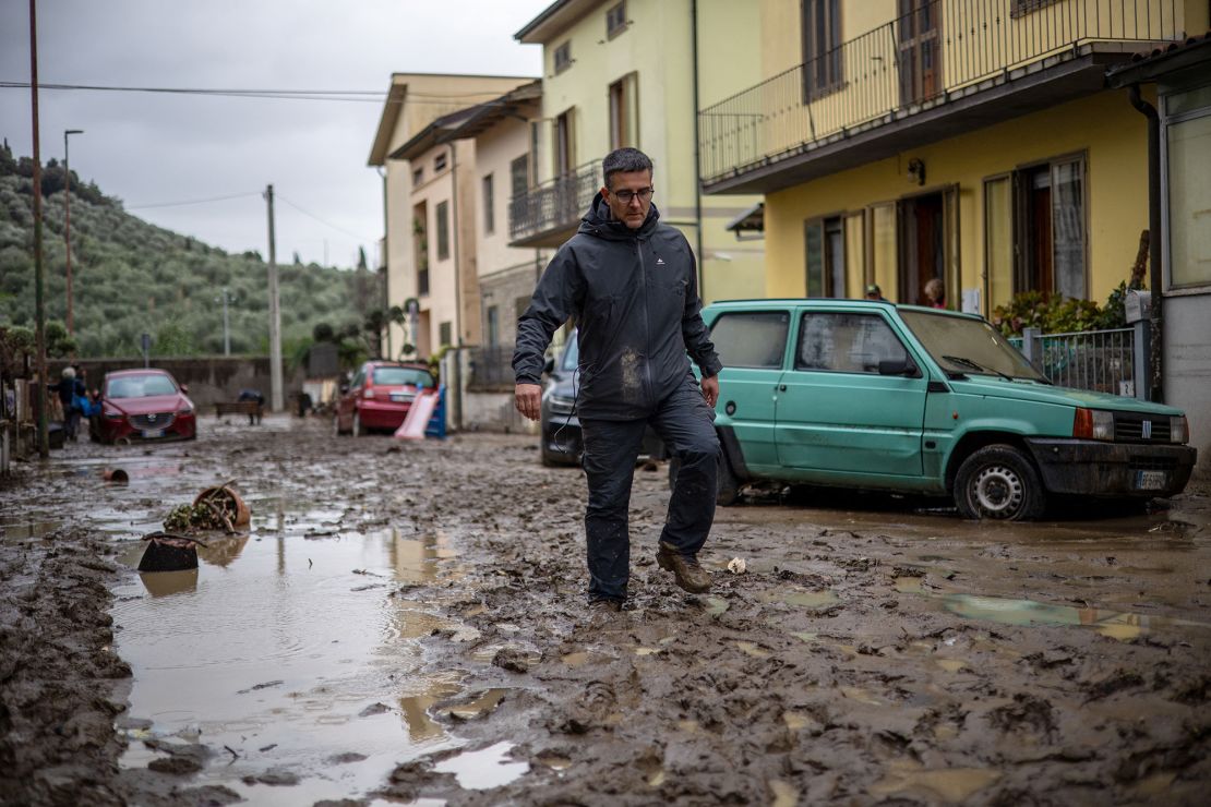 A man walks in the mud in Montemurlo, near Prato, after heavy rain last night, on November 3, 2023. Storm Ciaran hit Tuscany late on November 2, 2023 causing the death of five people according to authorities. (Photo by Federico SCOPPA / AFP) (Photo by FEDERICO SCOPPA/AFP via Getty Images)