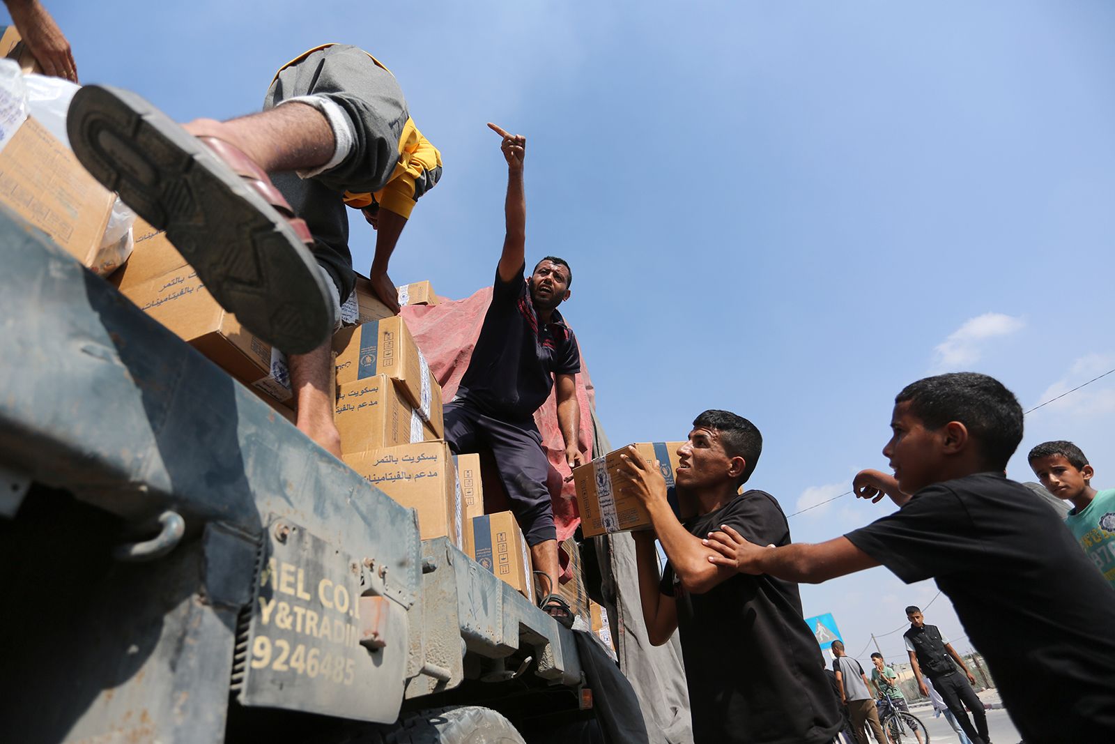 Palestinians take humanitarian aid from a truck near the Rafah border crossing in Gaza on November 2.