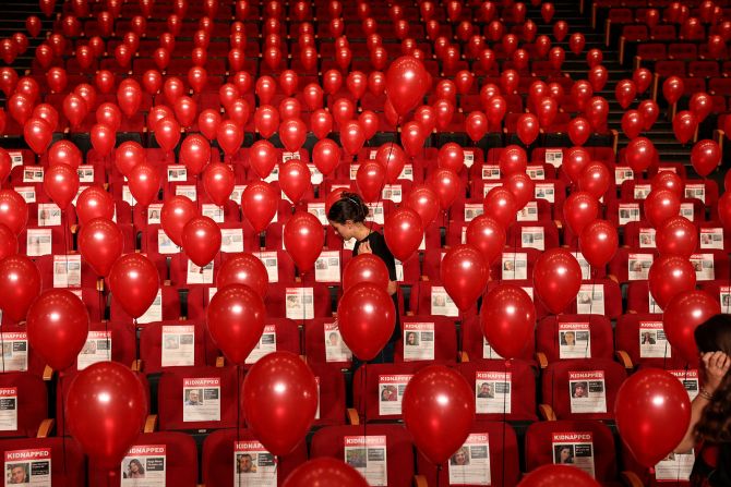 Pictures of Israeli hostages kidnapped by Hamas are displayed with balloons as part of an installation in Jerusalem on November 2.