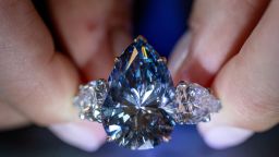 Christie's auction house intern Carola Chiadini holds the "Bleu Royal" diamond, weighing 17.61 carats, which is the largest to appear for sale in auction history and that could sell for up to $50 million during an auction preview in Geneva, Switzerland, November 1, 2023.