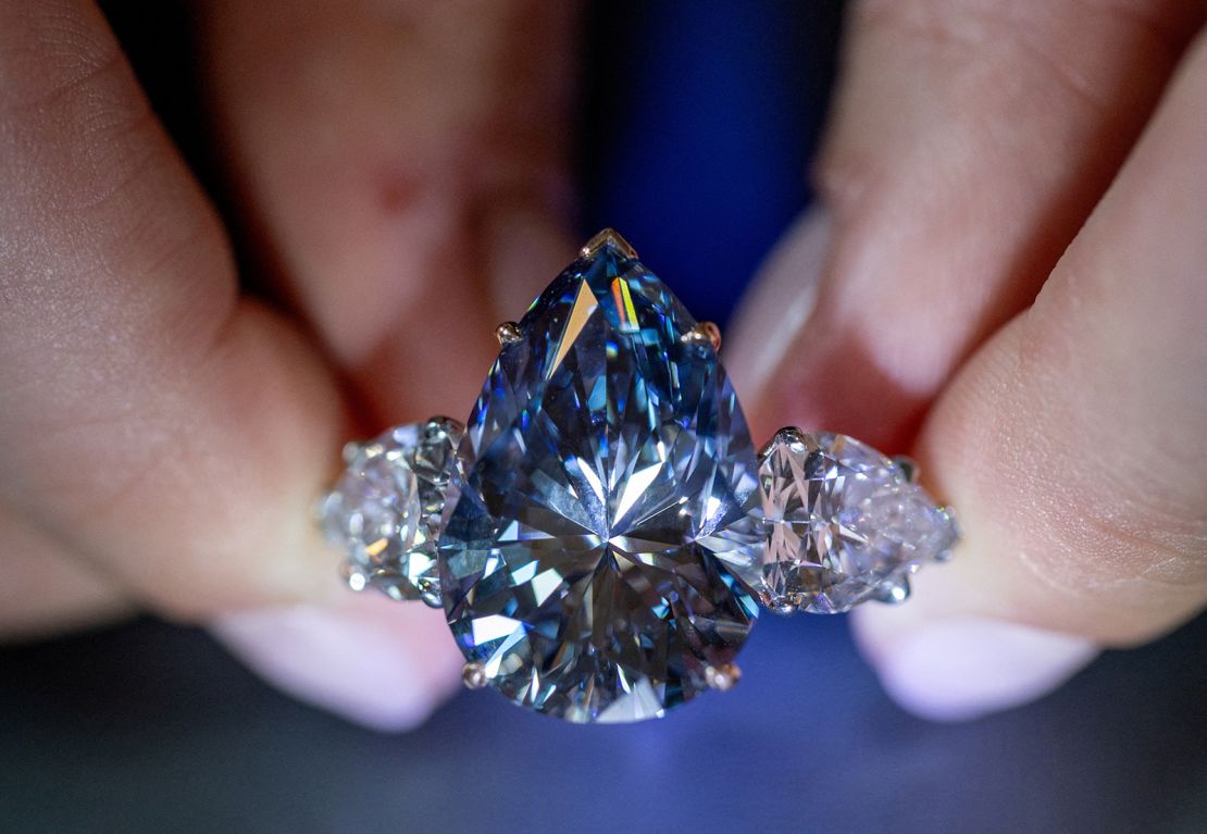 Christie's auction house intern Carola Chiadini holds the "Bleu Royal" diamond, weighing 17.61 carats, which is the largest to appear for sale in auction history and that could sell for up to $50 million during an auction preview in Geneva, Switzerland, November 1, 2023.