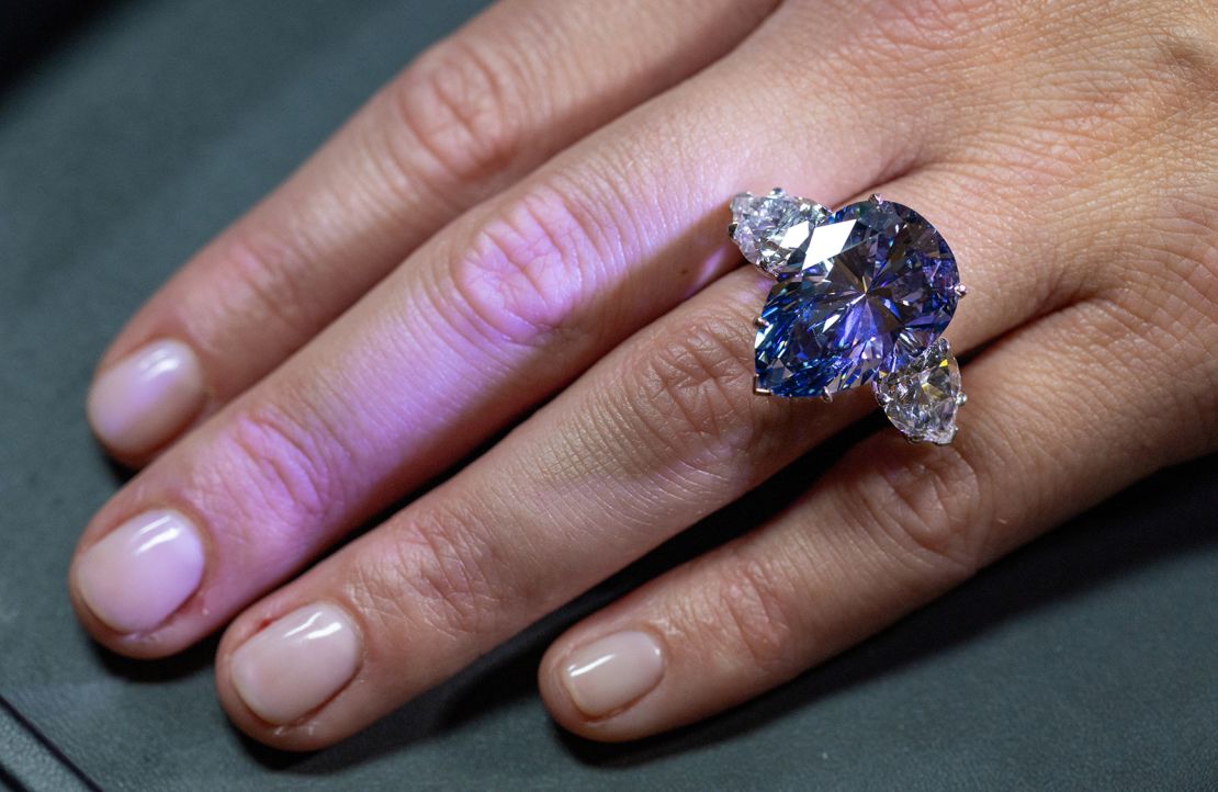 Christie's auction house intern Carola Chiadini holds the "Bleu Royal" diamond, weighing 17.61 carats, during an auction preview in Geneva, Switzerland, November 1, 2023.