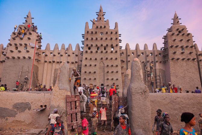 <strong>Old Towns of Djenné, Mali --</strong> Within one of the oldest towns in sub-Saharan Africa is the Great Mosque of Djenné. Part of the Old Towns of Djenné UNESCO site, the <a href="index.php?page=&url=https%3A%2F%2Fprojects.iq.harvard.edu%2Fwhoseculture%2Fmosque-djenne" target="_blank" target="_blank">mosque</a> was first built in the 13th century by King Mansa Musa. It was then restored in 1907 and is replastered annually during local festival "Crepissage de la Grand Mosquee" (Plastering of the Great Mosque).