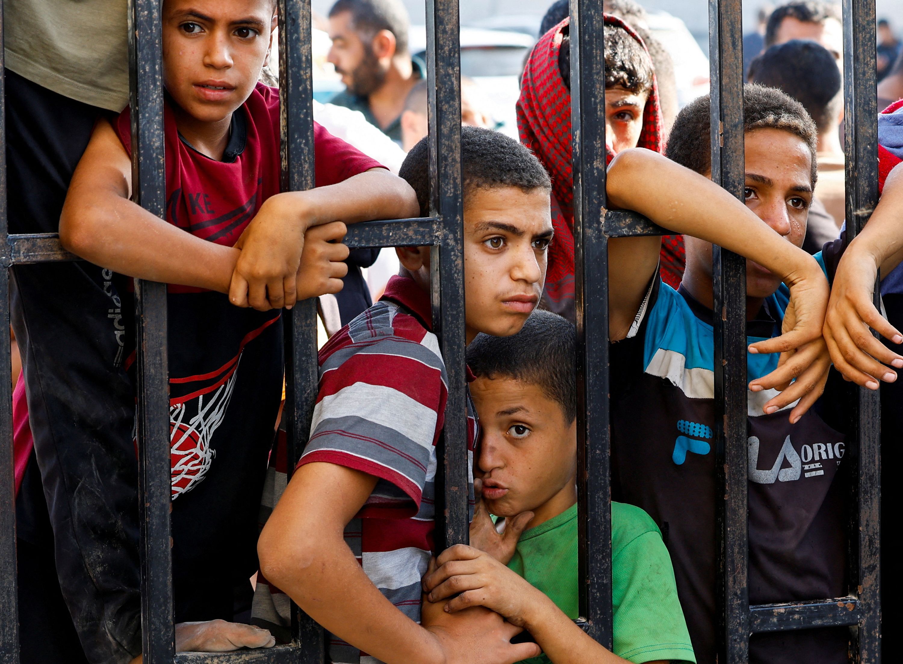 Children wait for the return of Palestinian workers from Israel at the Rafah border in southern Gaza, on November 3.