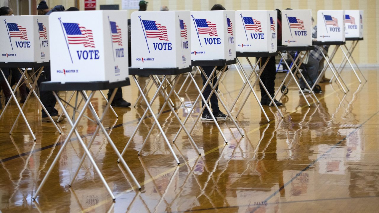 Voters cast ballots at a polling location in Southfield, Michigan, U.S., on Tuesday, Nov. 3, 2020. American voters, at least those who've not yet cast ballots, go to the polls Tuesday to choose between President Donald Trump and Democratic nominee Joe Biden and cast votes in U.S. House and Senate races and state and local elections.