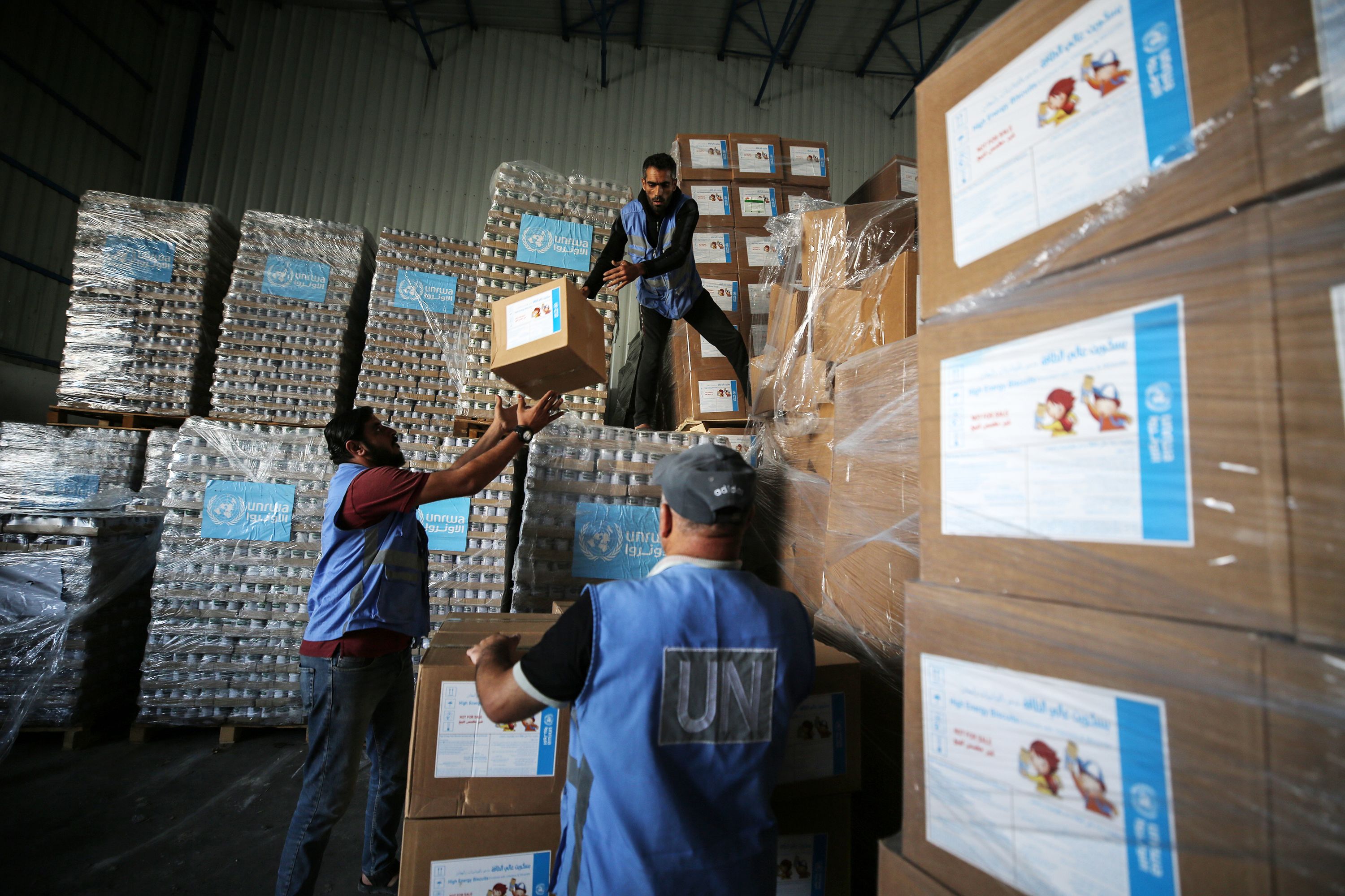 United Nations workers in the Nuseirat refugee camp in central Gaza prepare aid for distribution to Palestinians, who have fled their homes and are sheltering in a UN-run school, on November 4. 