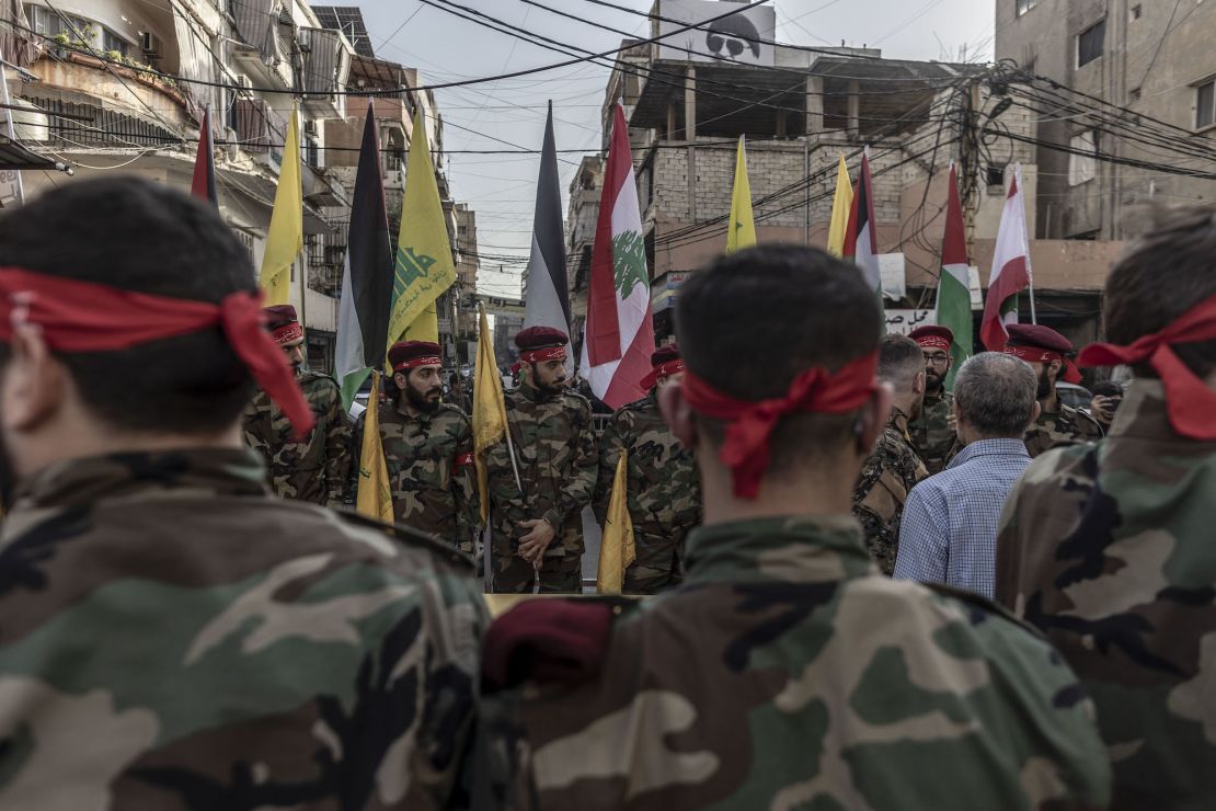 BEIRUT, LEBANON - OCTOBER 23: Hezbollah supporters in military clothes in formation within the area where the coffin will be honored moments before the beginning of the funeral of a Hezbollah militant killed by IDF while clashing yesterday in southern Lebanon yesterday, through the streets of Dahieh district on October 23, 2023 in Beirut, Lebanon. Lebanese Hezbollah announced the death of ten militants in the past 24 hours, bringing to 25 the number killed in its ranks since the large-scale Hamas attack in Israel on October 7. Accentuating the fear of a general conflagration on the Lebanese-Israeli front. (Photo by Manu Brabo/Getty Images)