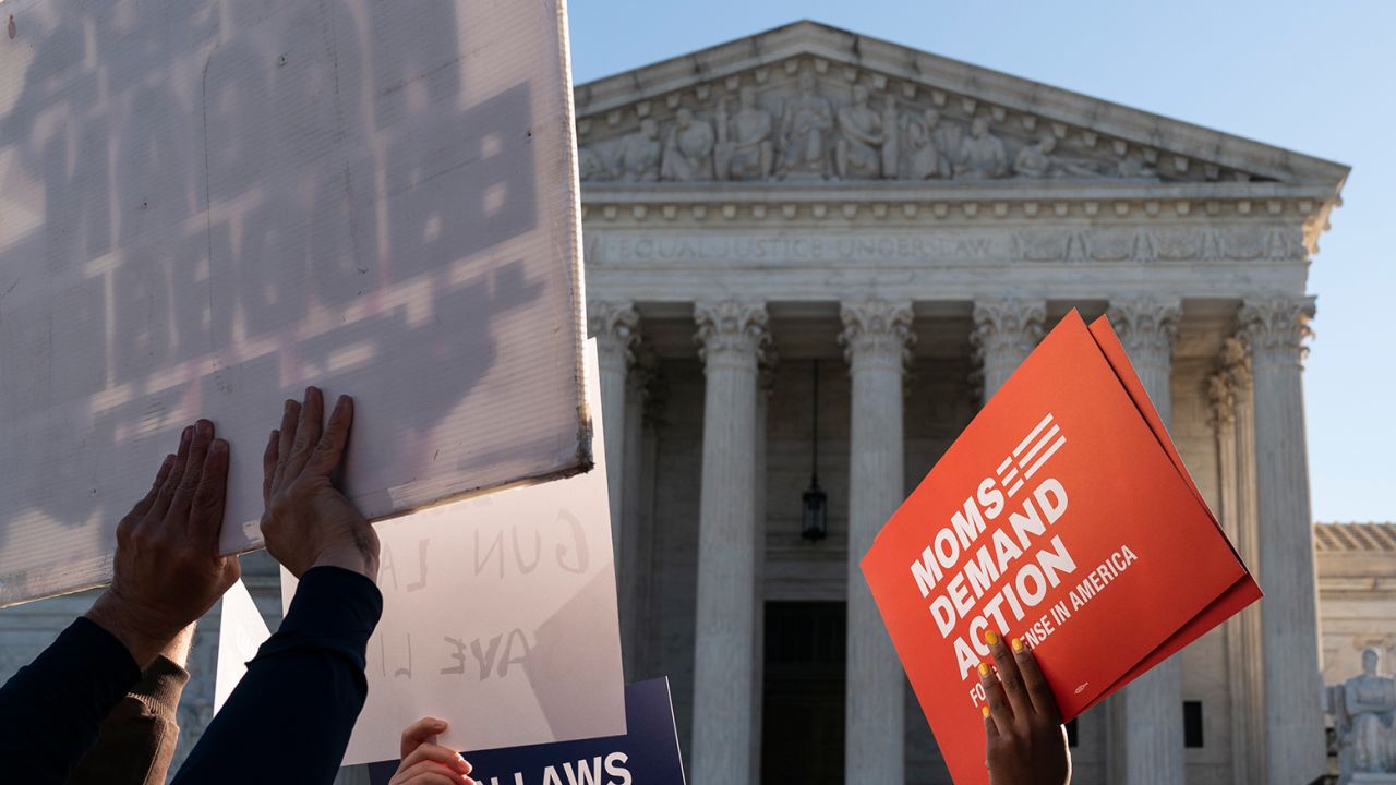 Supporters of gun control hold signs in front of supporters of gun rights during a demonstration by victims of gun violence in front of the Supreme Court as arguments begin in a major case on gun rights on November 3, 2021 in Washington, DC. The court is hearing a case on a New York law that imposes limits on the carrying of guns outside the home.