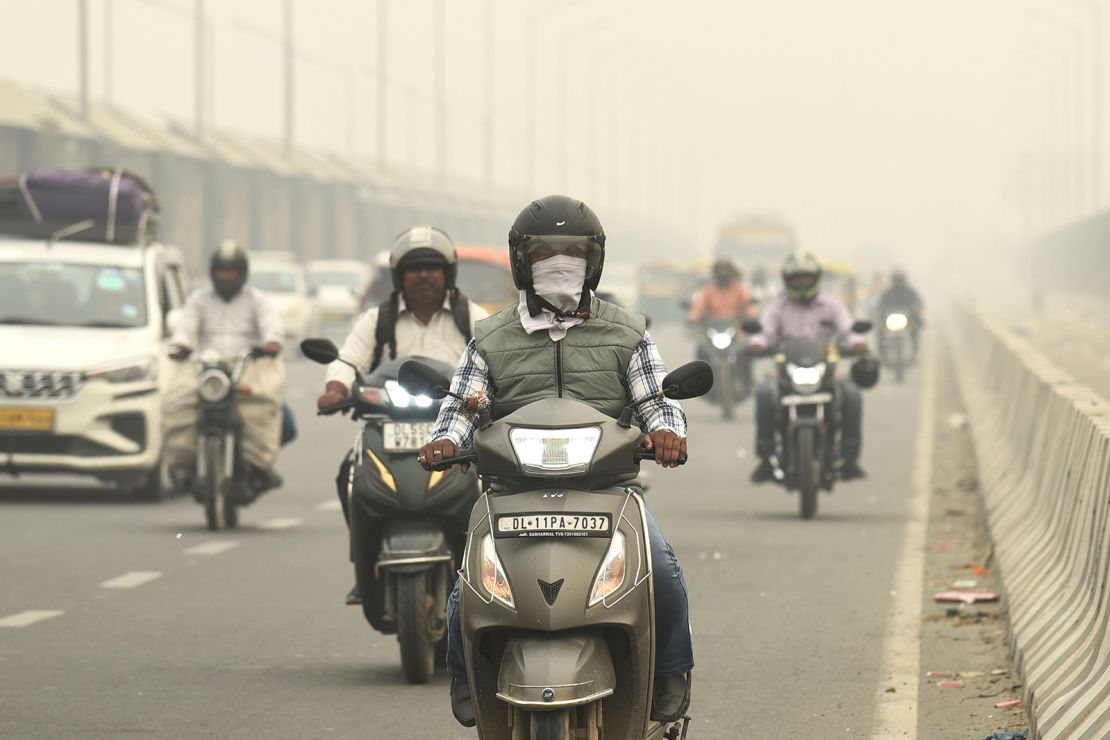 Traffic on a road enveloped by smog in New Delhi, India, on November 3.