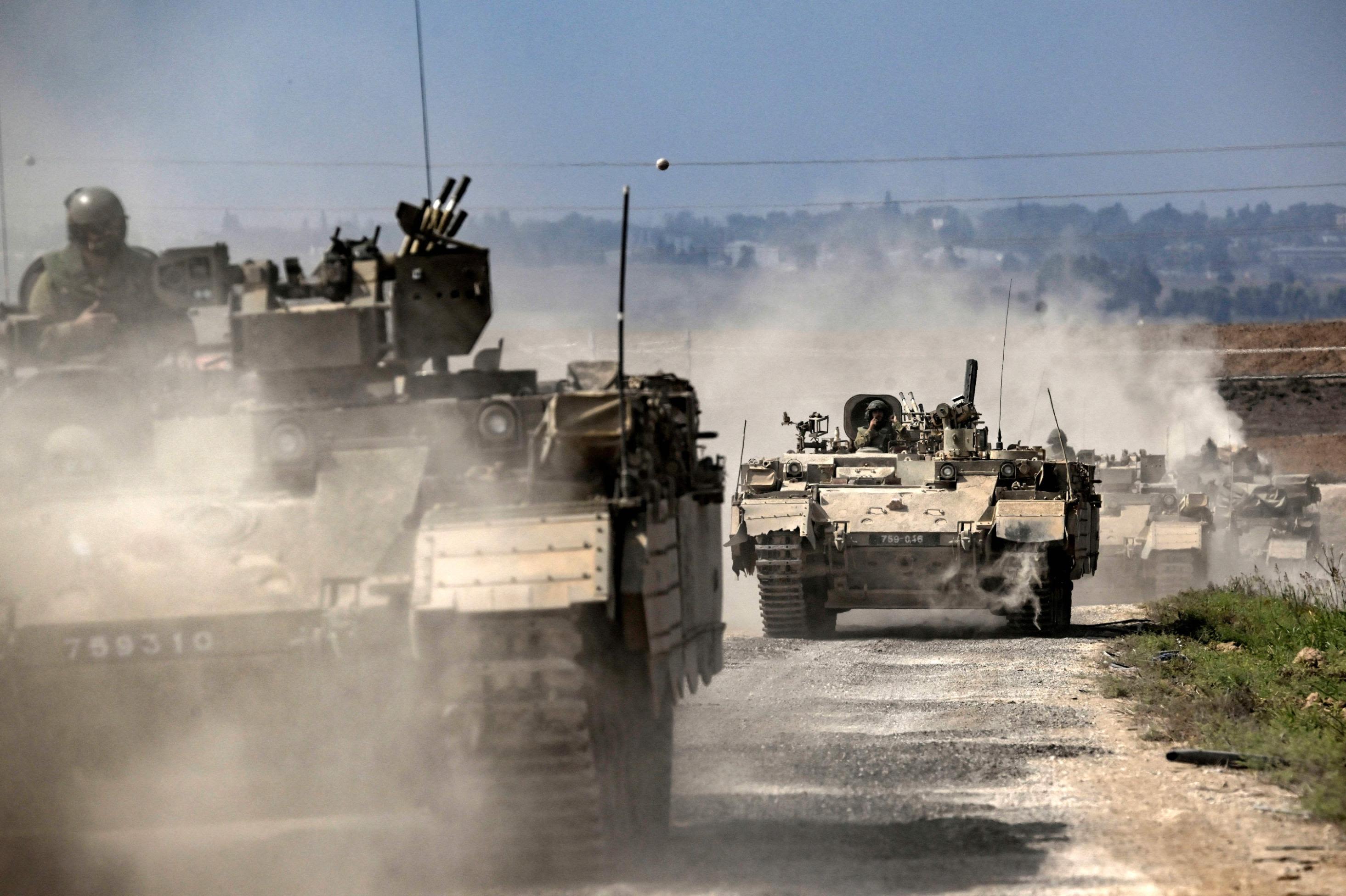 Israeli army Puma armored personnel carriers move in a column near the Gaza border in southern Israel on October 14.